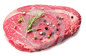 Ribeye steak with peppercorn and rosemary isolated on white background. Top view