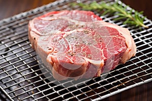 ribeye steak with sear marks on a wire rack