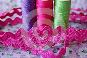 Ric rac with colorful spools of thread in purple, pink and green