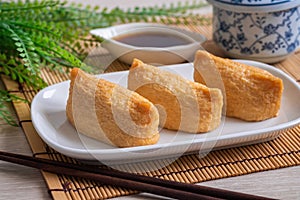 Rice ball wrapped in deep fried tofu pouches Inari Sushi, Japanese food photo