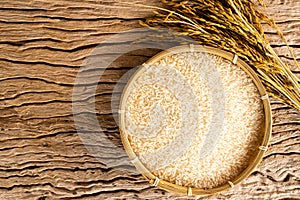 Rice in bamboo basket on rustic wood background,Rice of famer in Thailand