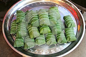 Rice in banana leaves on a tray, Asia