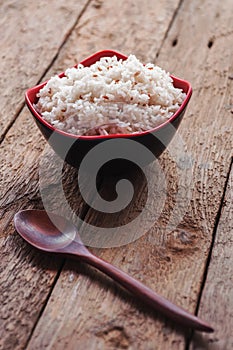 Rice berry, Brown rice in a bowl on brown wooden background, Sti