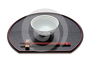 Rice bowl with chopsticks on tray