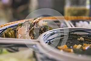 rice bowl with rattan, inside is traditional Vietnamese lunch, rice, soup, salty food. The scene is frugal and peaceful