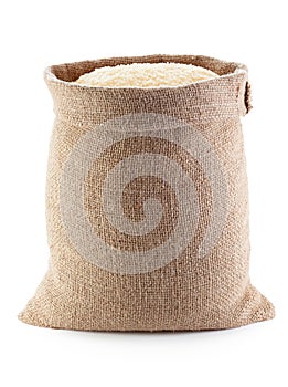 Rice in burlap sack, isolated on the white background