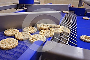 Rice cake puffed texture. conveyor automatic line for the production of useful whole grain extruder crispbread