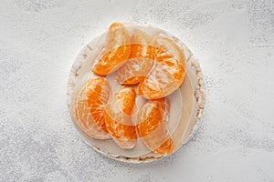 Rice cakes with nut butter and tangerine slices top view close up