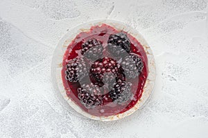 Rice cakes with raspberry jam and blackberries close-up top view