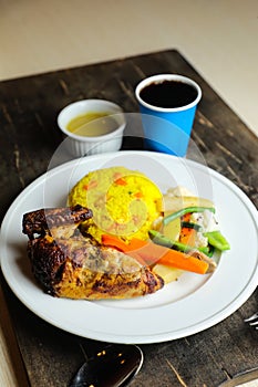 Rice with chicken Roast Meal with salad served in plate with sauce, cold drink, spoon and fork isolated on wooden board side view