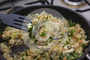 Rice with chicken on spatula