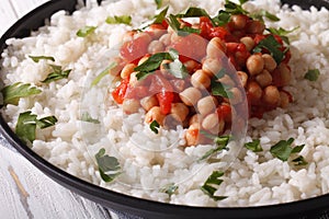 Rice with chickpeas, tomatoes and herbs close-up. Horizontal