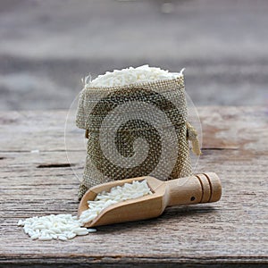 Rice in a cloth sack with a scoop is placed on the table.