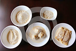 Rice and coconut desserts dunked in cream