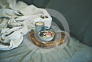 Rice coconut porridge and cup of espresso in bed