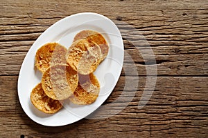Rice cracker with flossy pork on white plate photo