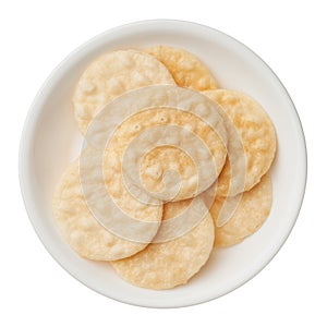 Rice crackers in a bowl isolated on white background