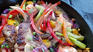 Rice dish with seafood and vegetables in a pan, close up in the food