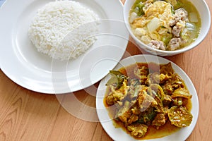 Rice eat with spicy stir fried wild boar curry and egg soup