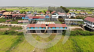 Rice fields from above on a windy day revealing traditionnal school painted blue