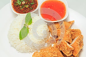 Rice with fried chicken and Thai style sauce and chili sauce
