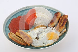 Rice with fried eggs tomato sauce and fried banana