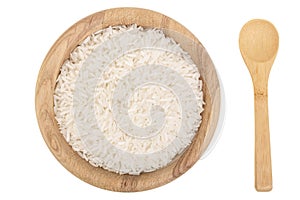 Rice grains in wooden bowl isolated on white background. Top view. Flat lay