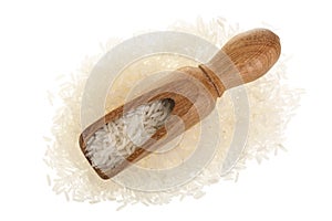 Rice grains in wooden scoop isolated on white background. Top view. Flat lay