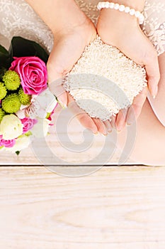 Rice in the hands of a bride