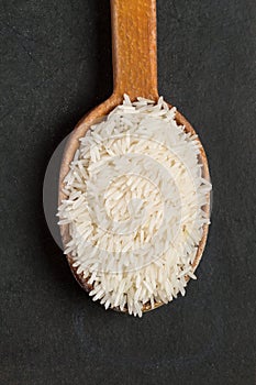 Rice Jasmine in an wooden spoon on a black background