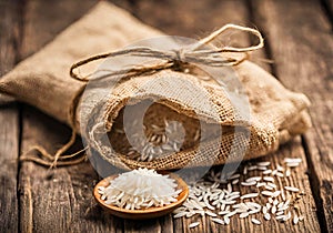 Rice in a jute bag on a wooden table.