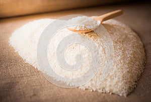 Rice laid out in a heart shape on sackcloth with wooden spoon