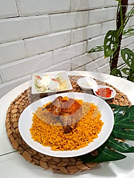 rice mandi with chicken, salad and chili as condiment