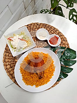 rice mandi with chicken, salad and chili as condiment