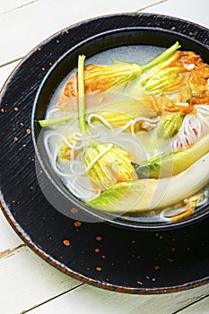 Rice noodle soup with pumpkin flowers