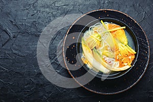 Rice noodle soup with pumpkin flowers,copy space