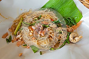 Rice noodle stir fry vegetables on the banana leaves.