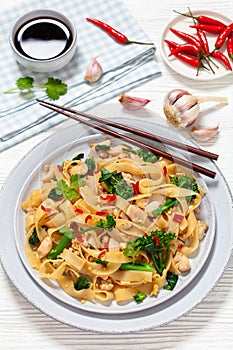rice noodles with chicken, eggs, chinese broccoli
