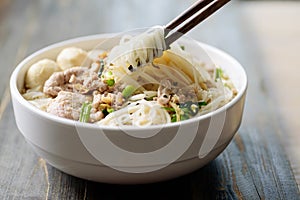 Rice noodles soup with pork and meat ball in a bowl