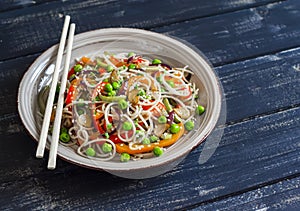 Rice noodles with vegetable stir fry on the ceramic plate