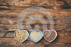 Rice, pasta, buckwheat, in bowl  heart shape