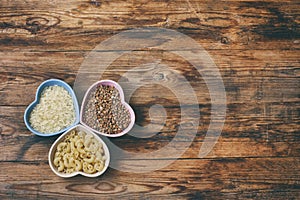 Rice, pasta, buckwheat, in bowl heart shape