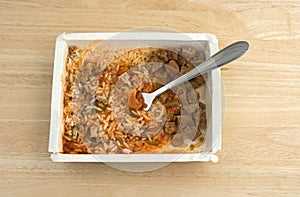 Rice peppers and beef chunks in paper tray with fork