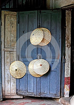 Rice picker hats on blue door photo