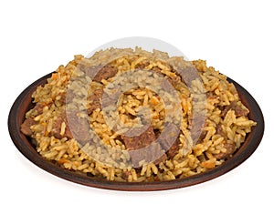 Rice pilaf with meat carrot and onion in a plate isolated on white background