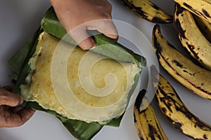 Rice plantain Ila ada. Steamed rice pancakes in banana leaf made with a rice flour dough mixed with mashed ripe plantain and sweet