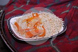 Rice on plate with carrot slices, Close up view - Food Photography