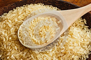 Rice on the plate with wooden spoon