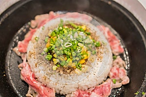 Rice and pork with corn served in hot pan