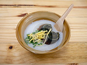 Rice porridge with century egg and ginger in a bowl